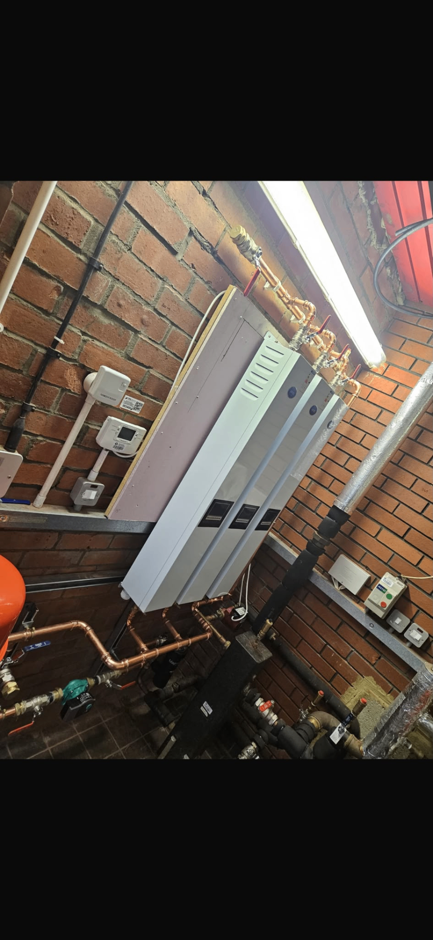 Commercial heating installation with multiple wall-mounted units and copper distribution pipework
